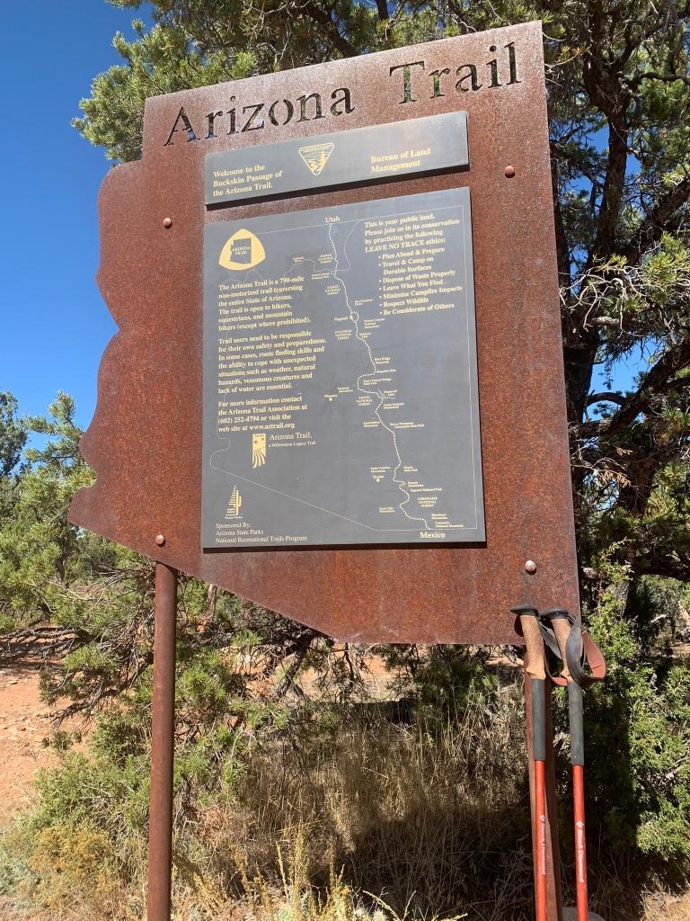 A metal Arizona Trail passage boundary sign cut into the shape of the state of Arizona marking the boundary between Passages 42 and 43.  